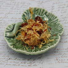 Load image into Gallery viewer, Mango tea on a geranium leaf dish