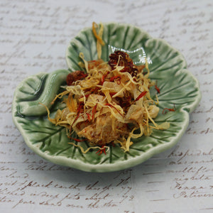 Mango tea on a geranium leaf dish